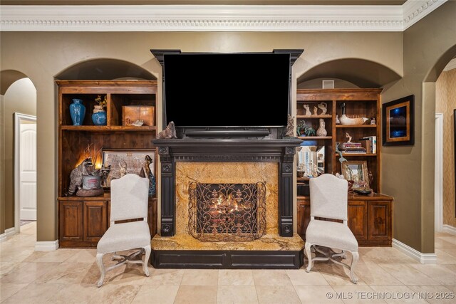 6317 E 110th St, Tulsa, OK 74137 - living area featuring arched walkways, a high end fireplace, ornamental molding, and baseboards