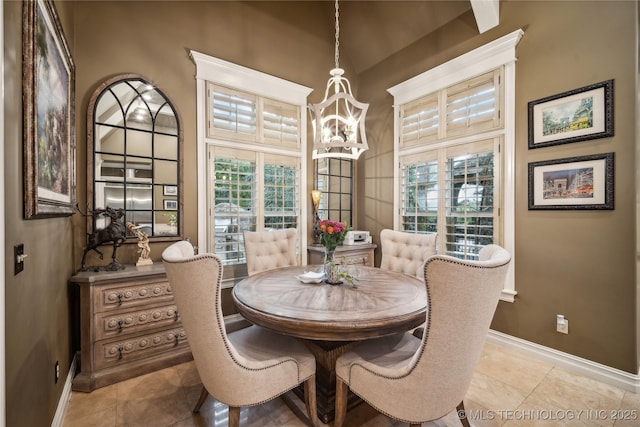 6317 E 110th St, Tulsa, OK 74137 - dining space featuring a chandelier, plenty of natural light, baseboards, and vaulted ceiling