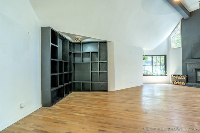3017 E 88th St, Tulsa, OK 74137 - unfurnished living room featuring wood finished floors, high vaulted ceiling, a large fireplace, baseboards, and beam ceiling