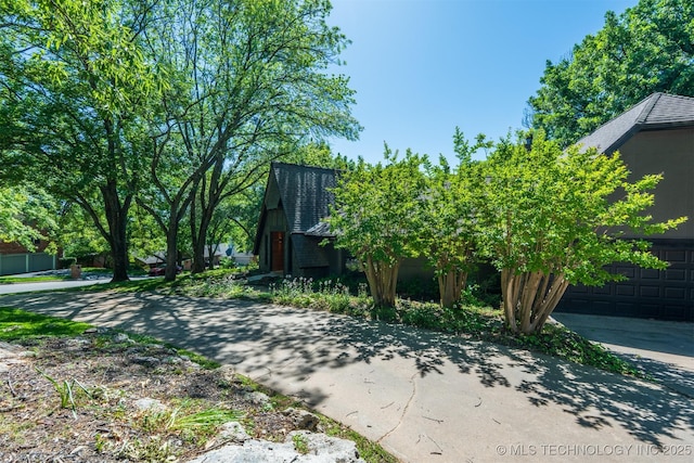 3017 E 88th St, Tulsa, OK 74137 - view of yard with a garage and concrete driveway