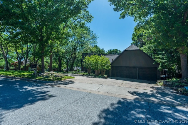 3017 E 88th St, Tulsa, OK 74137 - view of side of home featuring a garage