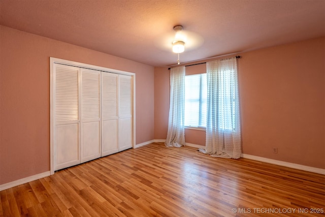 3017 E 88th St, Tulsa, OK 74137 - unfurnished bedroom with light wood-style floors, a closet, and baseboards