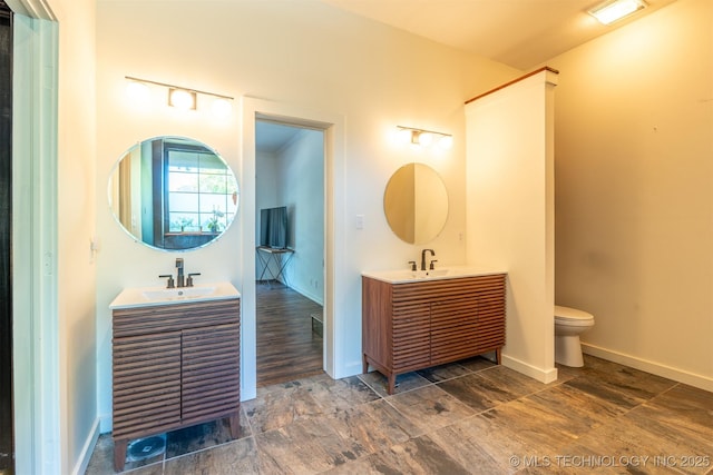 3017 E 88th St, Tulsa, OK 74137 - bathroom with two vanities, toilet, and baseboards