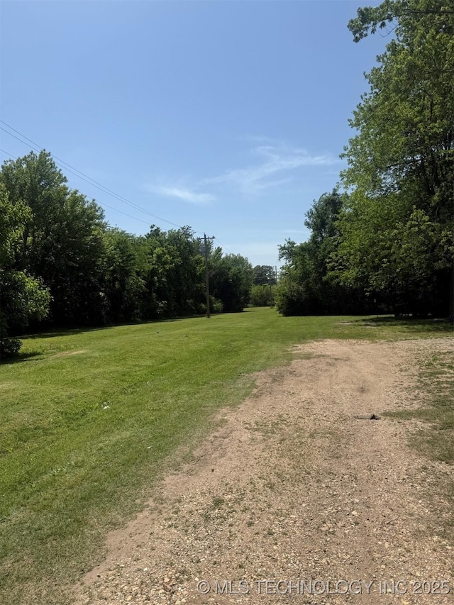 7 E Locust St, Stilwell, OK 74960 - view of green lawn featuring a view of trees