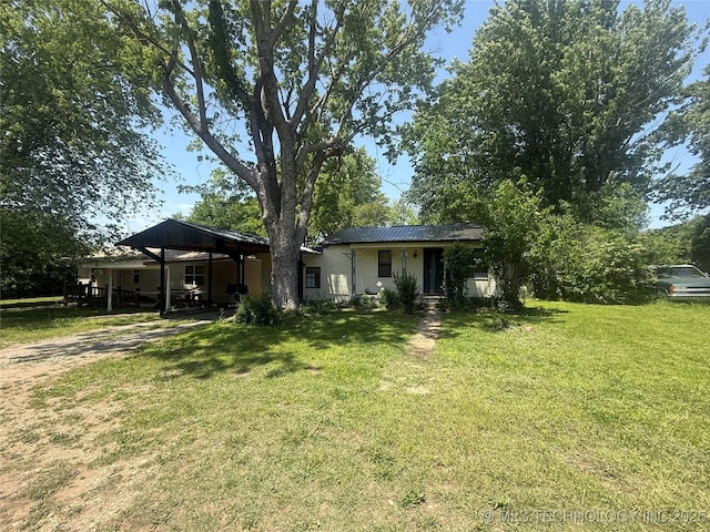 7 E Locust St, Stilwell, OK 74960 - back of house featuring a lawn