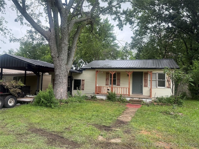 7 E Locust St, Stilwell, OK 74960 - ranch-style house with covered porch, a front lawn, and metal roof