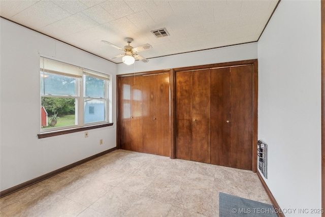 405 Dom Giaudrone, Mcalester, OK 74501 - unfurnished bedroom with baseboards, multiple closets, and ceiling fan