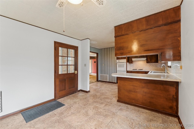405 Dom Giaudrone, Mcalester, OK 74501 - kitchen featuring a sink, baseboards, and light countertops