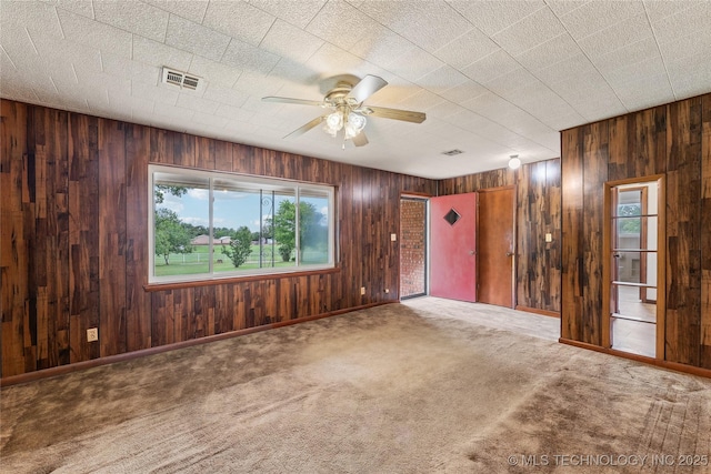 405 Dom Giaudrone, Mcalester, OK 74501 - empty room featuring wooden walls, a ceiling fan, carpet floors, and baseboards