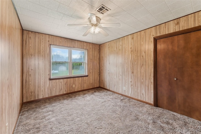 405 Dom Giaudrone, Mcalester, OK 74501 - carpeted spare room featuring a ceiling fan and wood walls