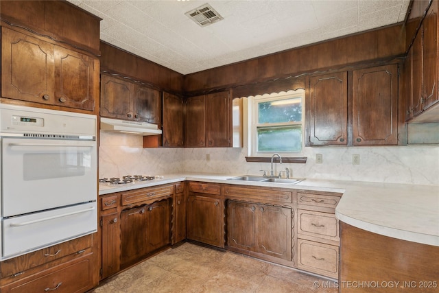 405 Dom Giaudrone, Mcalester, OK 74501 - kitchen with white appliances, a warming drawer, a sink, backsplash, and under cabinet range hood