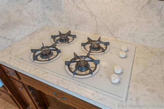 405 Dom Giaudrone, Mcalester, OK 74501 - kitchen view of an outdoor fire pit, light countertops, brown cabinetry, and white gas cooktop