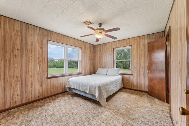 405 Dom Giaudrone, Mcalester, OK 74501 - carpeted bedroom featuring wood walls, baseboards, and a ceiling fan