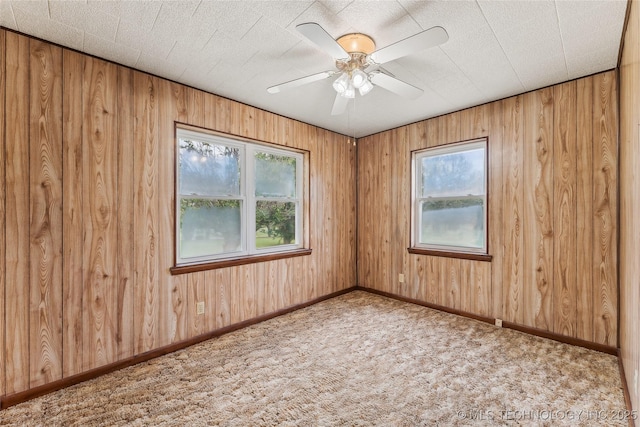 405 Dom Giaudrone, Mcalester, OK 74501 - carpeted spare room featuring healthy amount of natural light, ceiling fan, wood walls, and baseboards