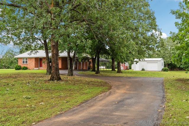 405 Dom Giaudrone, Mcalester, OK 74501 - view of front of property with asphalt driveway, a front lawn, an outdoor structure, and brick siding