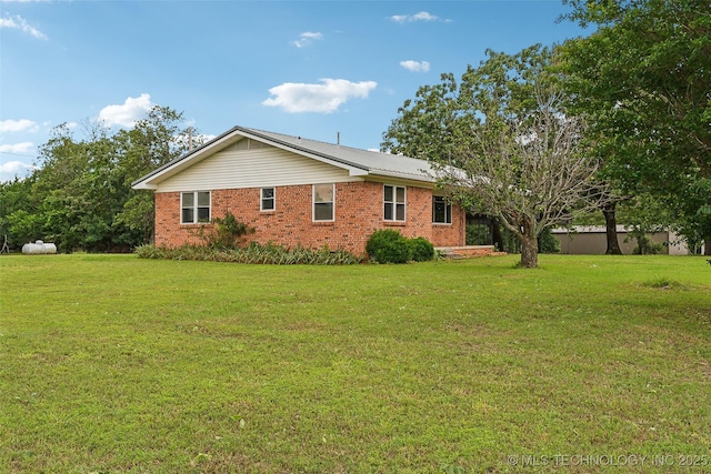 405 Dom Giaudrone, Mcalester, OK 74501 - view of property exterior featuring a lawn and brick siding