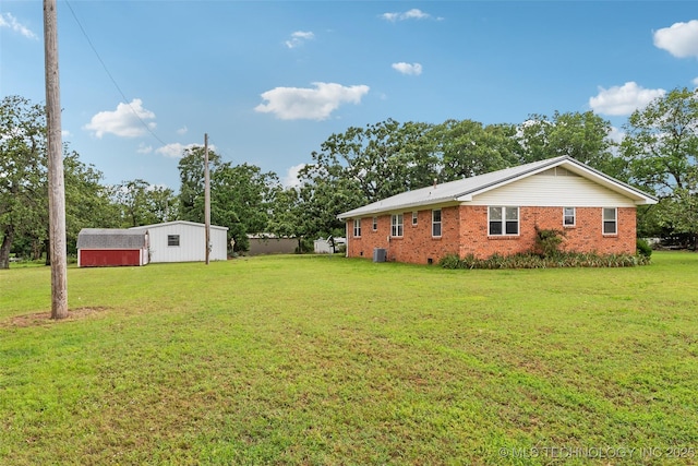 405 Dom Giaudrone, Mcalester, OK 74501 - view of green lawn featuring an outdoor structure, central air condition unit, and an outbuilding