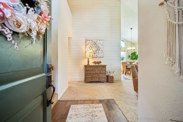 719 W Teel Rd, Sapulpa, OK 74066 - foyer entrance with dark wood-type flooring, wood walls, and lofted ceiling