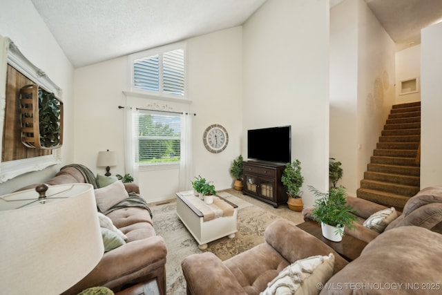 719 W Teel Rd, Sapulpa, OK 74066 - living area with high vaulted ceiling, healthy amount of natural light, stairway, and a ceiling fan