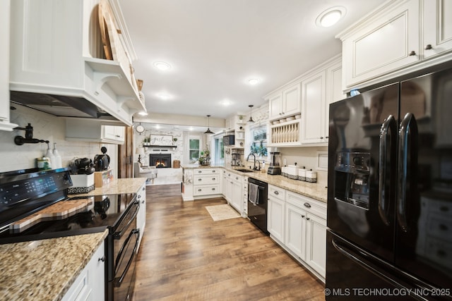 719 W Teel Rd, Sapulpa, OK 74066 - kitchen featuring black appliances, a sink, open shelves, white cabinetry, and a peninsula