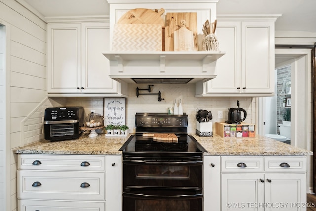 719 W Teel Rd, Sapulpa, OK 74066 - kitchen with range with two ovens, tasteful backsplash, white cabinets, and light stone counters