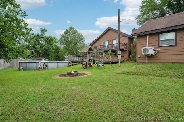 719 W Teel Rd, Sapulpa, OK 74066 - view of green lawn featuring an outdoor pool, a fire pit, a wooden deck, and a cooling unit
