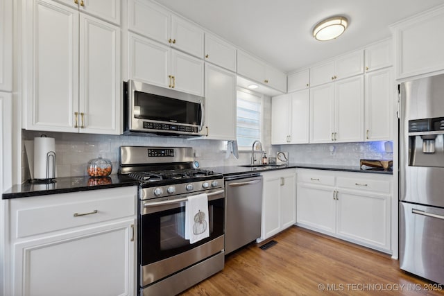 4104 S Owasso Ave, Tulsa, OK 74105 - kitchen with stainless steel appliances, a sink, and white cabinetry