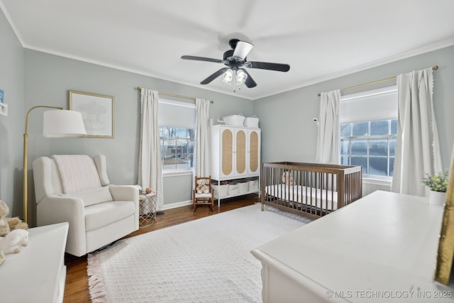 4104 S Owasso Ave, Tulsa, OK 74105 - bedroom featuring a crib, wood finished floors, ornamental molding, baseboards, and a ceiling fan