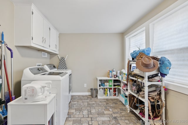 4104 S Owasso Ave, Tulsa, OK 74105 - laundry area featuring washer and dryer, cabinet space, baseboards, and light stone finish floors
