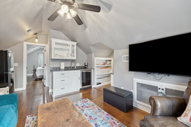 4104 S Owasso Ave, Tulsa, OK 74105 - living area featuring wine cooler, bar with sink, lofted ceiling, ceiling fan, and dark wood finished floors
