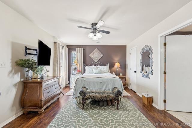 805 E 10th St, Claremore, OK 74017 - bedroom with wood finished floors, ceiling fan, and baseboards