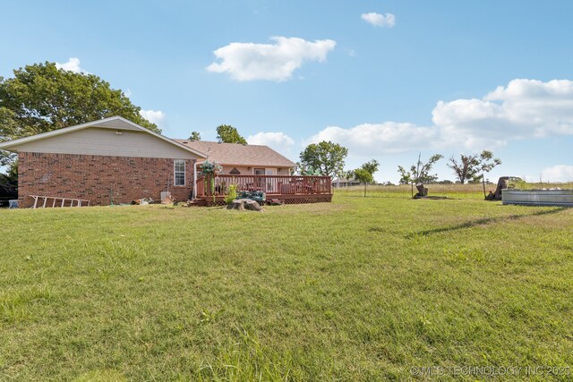 805 E 10th St, Claremore, OK 74017 - view of green lawn featuring a wooden deck