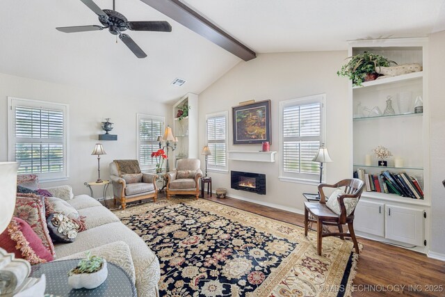 805 E 10th St, Claremore, OK 74017 - living area featuring wood finished floors, a glass covered fireplace, a ceiling fan, and baseboards