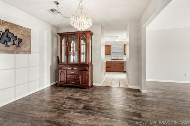 1309 N Willow Ave, Broken Arrow, OK 74012 - entryway with a chandelier, dark wood-type flooring, baseboards, and a ceiling fan