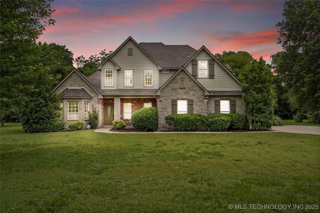 13041 E 67th St, Broken Arrow, OK 74012 - traditional home featuring a lawn, stone siding, and a shingled roof