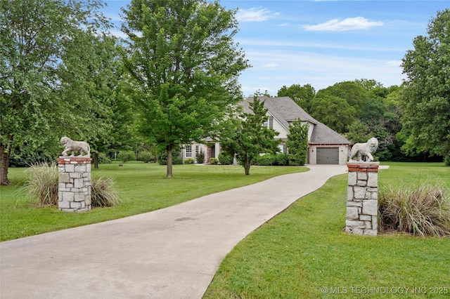 13041 E 67th St, Broken Arrow, OK 74012 - view of home's community featuring driveway, a lawn, and an attached garage