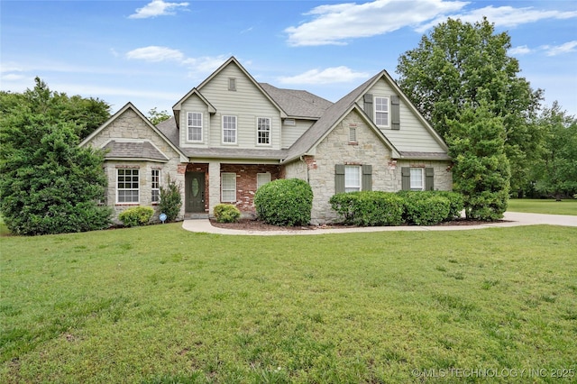 13041 E 67th St, Broken Arrow, OK 74012 - traditional-style home featuring stone siding, a front lawn, and roof with shingles