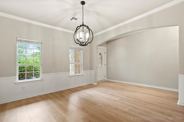 13041 E 67th St, Broken Arrow, OK 74012 - spare room featuring a chandelier, light wood-type flooring, arched walkways, plenty of natural light, and crown molding