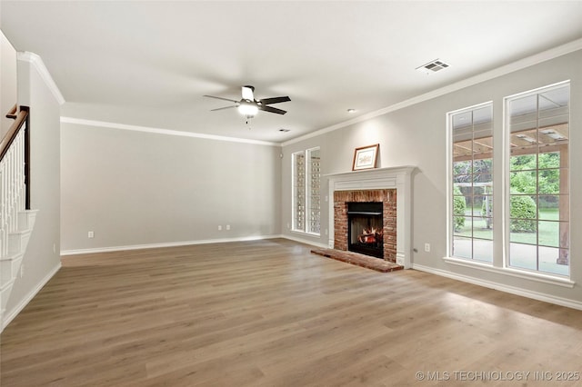 13041 E 67th St, Broken Arrow, OK 74012 - unfurnished living room featuring light wood finished floors, a ceiling fan, ornamental molding, baseboards, and a brick fireplace