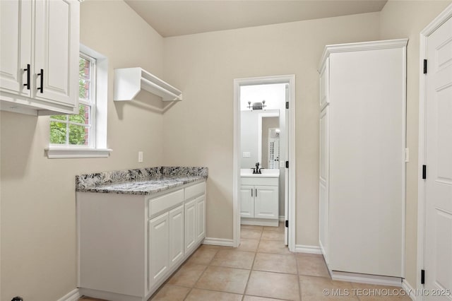13041 E 67th St, Broken Arrow, OK 74012 - washroom featuring a sink, baseboards, and light tile patterned flooring
