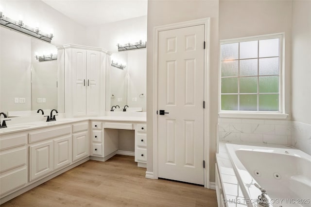 13041 E 67th St, Broken Arrow, OK 74012 - bathroom featuring double vanity, a tub with jets, and wood finished floors