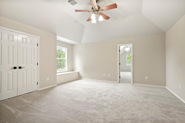 13041 E 67th St, Broken Arrow, OK 74012 - unfurnished bedroom featuring carpet, multiple windows, lofted ceiling, and baseboards