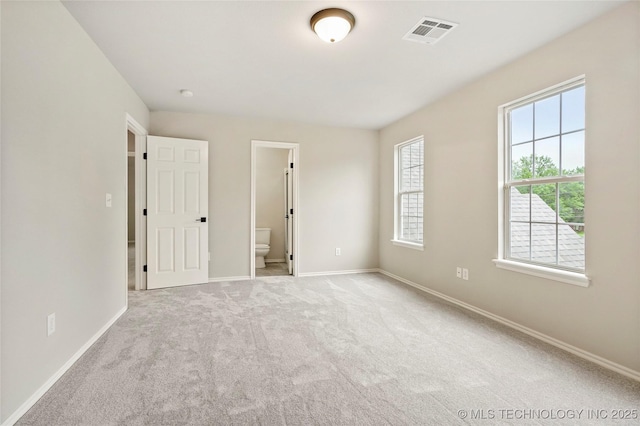 13041 E 67th St, Broken Arrow, OK 74012 - unfurnished bedroom with carpet flooring, baseboards, and ensuite bath