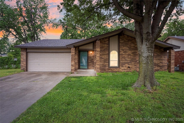 901 S Lions Ave, Broken Arrow, OK 74012 - mid-century inspired home with an attached garage, concrete driveway, a front yard, and brick siding
