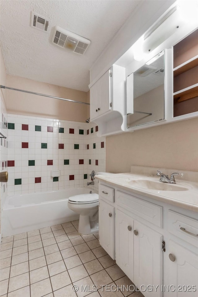901 S Lions Ave, Broken Arrow, OK 74012 - bathroom with vanity, washtub / shower combination, tile patterned flooring, toilet, and a textured ceiling