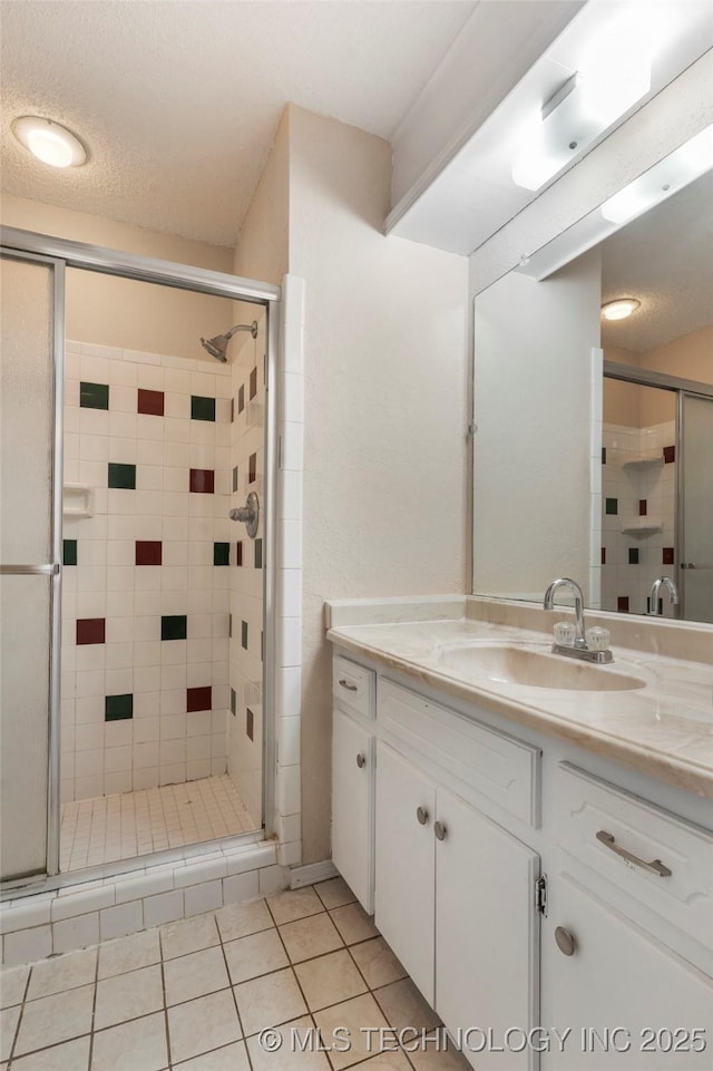 901 S Lions Ave, Broken Arrow, OK 74012 - bathroom with vanity, a stall shower, and tile patterned floors