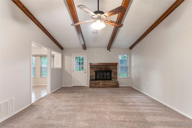 901 S Lions Ave, Broken Arrow, OK 74012 - unfurnished living room with carpet floors, beam ceiling, a fireplace, ceiling fan, and baseboards
