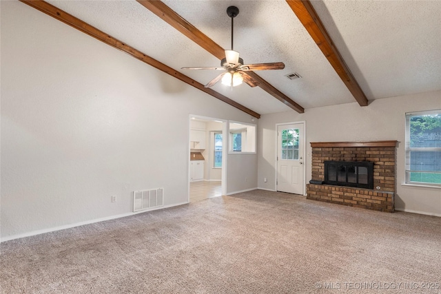 901 S Lions Ave, Broken Arrow, OK 74012 - unfurnished living room featuring a ceiling fan, carpet flooring, a textured ceiling, healthy amount of natural light, and a fireplace