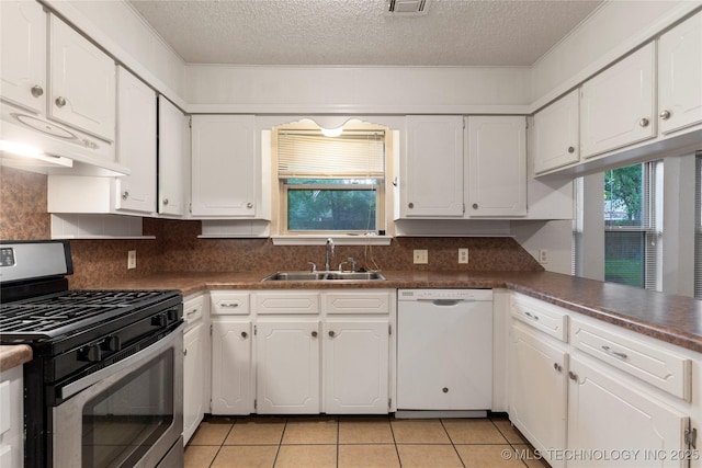 901 S Lions Ave, Broken Arrow, OK 74012 - kitchen with stainless steel range with gas stovetop, white dishwasher, a sink, white cabinetry, and a textured ceiling