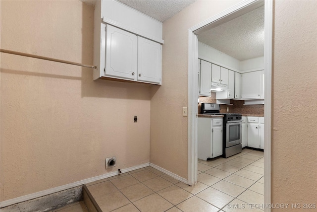 901 S Lions Ave, Broken Arrow, OK 74012 - washroom with a textured ceiling, light tile patterned floors, baseboards, and hookup for an electric dryer